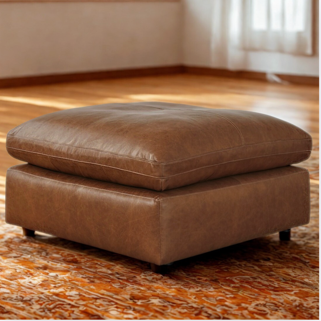Ashley Furniture Atlas Reserve oversized accent ottoman in caramel color with plush fabric and sturdy wooden legs.