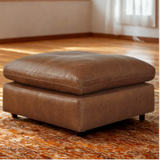 Ashley Furniture Atlas Reserve oversized accent ottoman in caramel color with plush fabric and sturdy wooden legs.