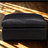 Ashley Furniture Atlas Reserve oversized accent Ottoman in caramel fabric, showing a plush, tufted design with sturdy wooden legs.