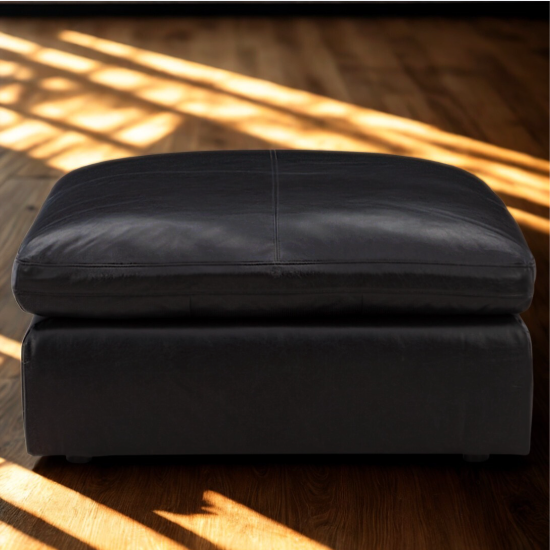 Ashley Furniture Atlas Reserve oversized accent Ottoman in caramel fabric, showing a plush, tufted design with sturdy wooden legs.