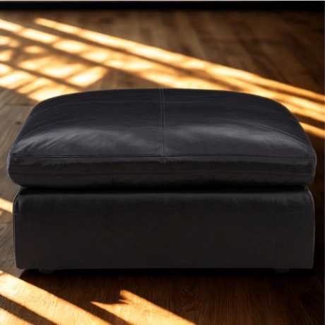 Ashley Furniture Atlas Reserve oversized accent Ottoman in caramel fabric, showing a plush, tufted design with sturdy wooden legs.