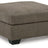 Oversized Ashley Furniture Mahoney accent ottoman with plush fabric and modern design, positioned in a living room setting.