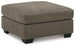 Oversized Ashley Furniture Mahoney accent ottoman with plush fabric and modern design, positioned in a living room setting.