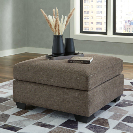 Mahoney oversized accent ottoman by Ashley Furniture with plush fabric and a sturdy wooden base, perfect for living room decor.