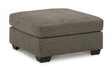 Oversized Mahoney accent ottoman by Ashley Furniture with soft fabric and plush cushioning, placed in a modern living room setting.