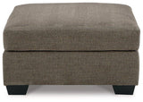 Mahoney oversized accent ottoman by Ashley Furniture with plush fabric, serving as a versatile living room footrest or extra seating.