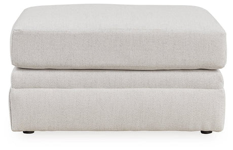Ashley Furniture Adda Ottoman with plush fabric, featuring a soft, cushioned top and wooden legs for versatile living room seating.