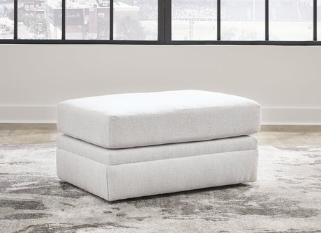 Ashley Furniture Adda Ottoman with plush fabric and wooden legs, providing stylish and functional seating or footrest.