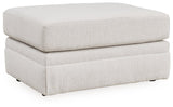 Ashley Furniture Adda Ottoman, upholstered storage ottoman with wooden legs, shown from an angled side view.