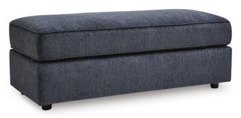 Large Ashley Furniture Albar Place oversized accent ottoman with plush fabric and modern design, shown in a cozy living room setting.