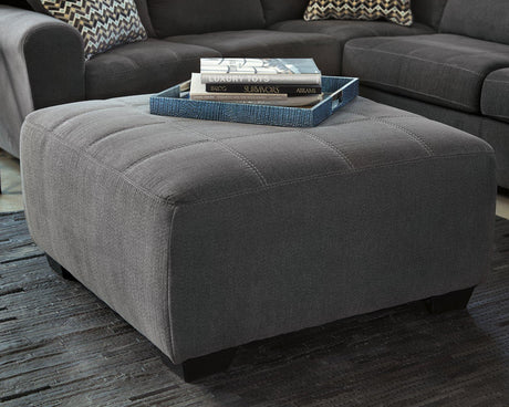 Ashley Furniture Ambee oversized accent ottoman with plush fabric and sturdy wooden legs, perfect for living room decor.