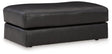 Ashley Furniture Amiata Ottoman with dark wood legs and upholstered fabric top, perfect for living room seating or decor.