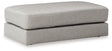 A plush oversized accent ottoman by Ashley Furniture with soft fabric upholstery, perfect for living room decor.