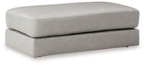 A plush oversized accent ottoman by Ashley Furniture with soft fabric upholstery, perfect for living room decor.