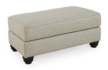 Ashley Furniture Asanti Ottoman featuring plush fabric and a sturdy wooden base, perfect for living room decor.