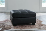 Oversized Ashley Furniture Barlin Mills accent ottoman with plush fabric and sturdy wooden legs, suitable as a versatile living room accent piece.