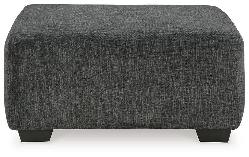 Oversized Ashley Furniture Biddeford Accent Ottoman with plush fabric and sturdy wooden legs, perfect for living room decor.