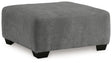 Oversized Ashley Furniture Birkdale Court accent ottoman with plush upholstery and wooden legs, designed for stylish living room decor.