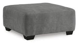 Oversized Ashley Furniture Birkdale Court accent ottoman with plush fabric and sturdy wooden legs, ideal for living room decor.