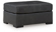 Ashley Furniture Brindley Pier oversized accent Ottoman with plush fabric and contemporary design, shown from an angled side view.