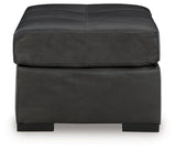 Ashley Furniture Brindley Pier oversized accent ottoman with neutral fabric and plush cushion, shown from a side angle.