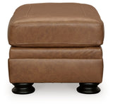 Ashley Furniture Carianna Ottoman in beige fabric, showing a plush cushion and wooden legs on a neutral background.