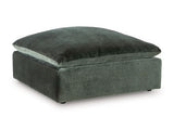Ashley Furniture Carriage View oversized accent ottoman with tufted fabric and wooden legs, shown from an angle.
