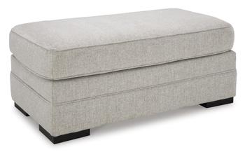Ashley Furniture Eastonbridge Ottoman featuring a plush fabric surface and wooden legs for versatile home decor and seating.