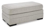 Ashley Furniture Eastonbridge Ottoman featuring a plush fabric surface and wooden legs for versatile home decor and seating.