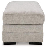 Ashley Furniture Eastonbridge Ottoman with soft fabric upholstery and wooden legs, designed as a versatile living room accent piece