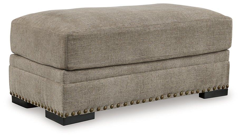 Ashley Furniture Galemore Ottoman showing plush fabric upholstery and wooden legs, ideal for living room decor.