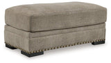 Ashley Furniture Galemore Ottoman showing plush fabric upholstery and wooden legs, ideal for living room decor.