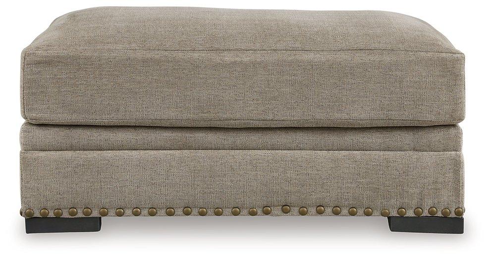 Ashley Furniture Galemore Ottoman with plush fabric and wooden legs, showcasing a stylish and functional living room accent piece.