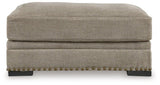 Ashley Furniture Galemore Ottoman with plush fabric and wooden legs, showcasing a stylish and functional living room accent piece.