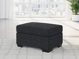 Ashley Furniture Jasmine Peaks Ottoman with plush fabric and wooden legs, showcasing a stylish, versatile ottoman for living rooms.