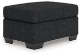 Ashley Furniture Jasmine Peaks Ottoman with plush fabric and wooden legs, shown from an angled view.