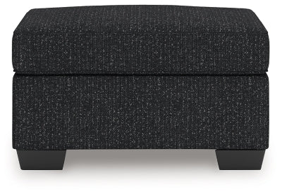 Ashley Furniture Jasmine Peaks Ottoman with plush fabric and wood legs, shown from a front head-on view.