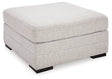 Ashley Furniture Koralynn oversized accent ottoman with a soft fabric cover and plush cushioning, shown from an angled side view.