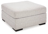 Ashley Furniture Koralynn oversized accent ottoman with a soft fabric cover and plush cushioning, shown from an angled side view.