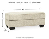 Ashley Furniture Monaghan Ottoman featuring a soft fabric surface and sturdy wooden legs in a modern design.