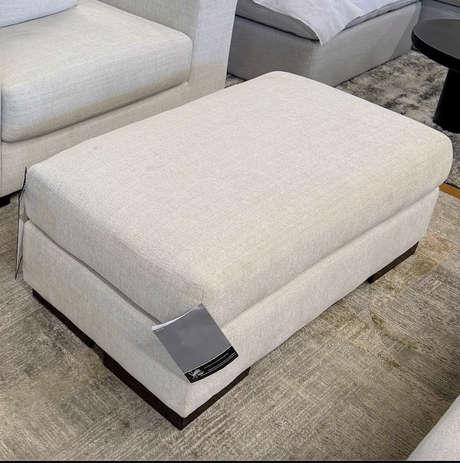 Ashley Furniture Newport Ottoman, plush fabric with tufted top and wooden legs, serving as a stylish accent or footrest.
