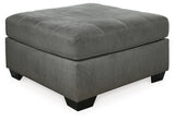 Ashley Furniture Pitkin oversized accent ottoman with soft fabric upholstery and sturdy wooden legs, ideal for living room decor.