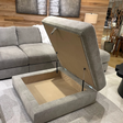 Ashley Furniture Riverview Ottoman with storage, featuring a plush fabric upholstery and a sturdy wooden base.