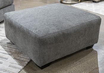 Ashley Furniture Seyler Lane oversized accent ottoman with plush fabric and tufted top, used as a stylish living room footrest or accent piece.