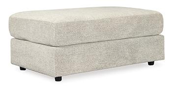Ashley Furniture Soletren Oversized Ottoman in neutral fabric with plush cushioning and wooden legs, ideal for living room seating.