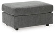 Ashley Furniture Stairatt Ottoman in neutral fabric with a cushioned top and wooden legs, ideal for living room or bedroom decor.