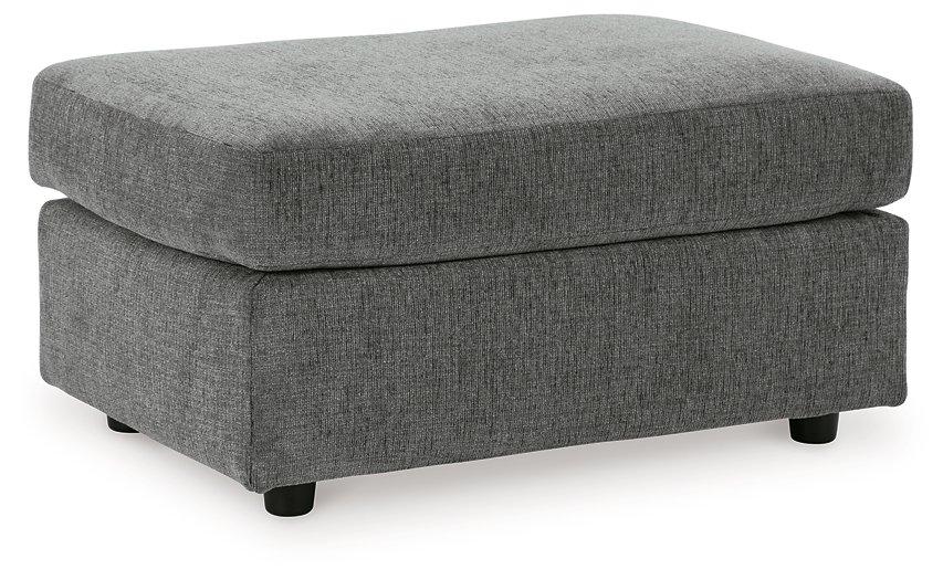 Ashley Furniture Stairatt Ottoman in neutral fabric with a cushioned top and wooden legs, ideal for living room or bedroom decor.