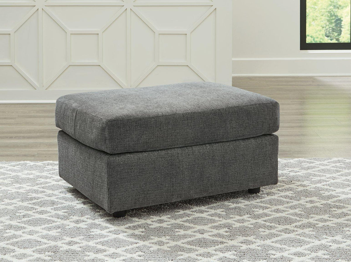 Ashley Furniture Stairatt Ottoman with plush fabric and storage space, shown in a cozy living room setting.