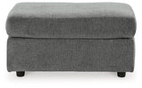 Ashley Furniture Stairatt Ottoman in neutral fabric with plush cushioning and wooden legs, used as a versatile footrest or side table.