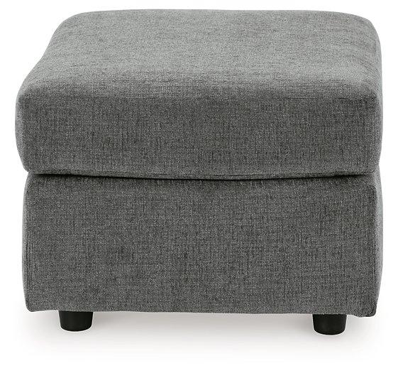 Ashley Furniture Stairatt Ottoman with plush fabric and wooden legs, showcasing its versatile, modern design.